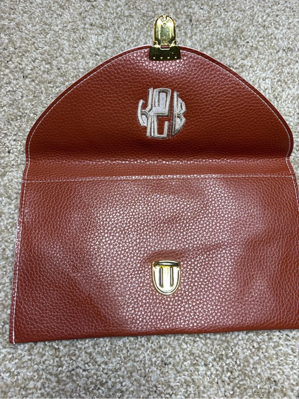 Monogram Convertible Clutch in Rust Brown